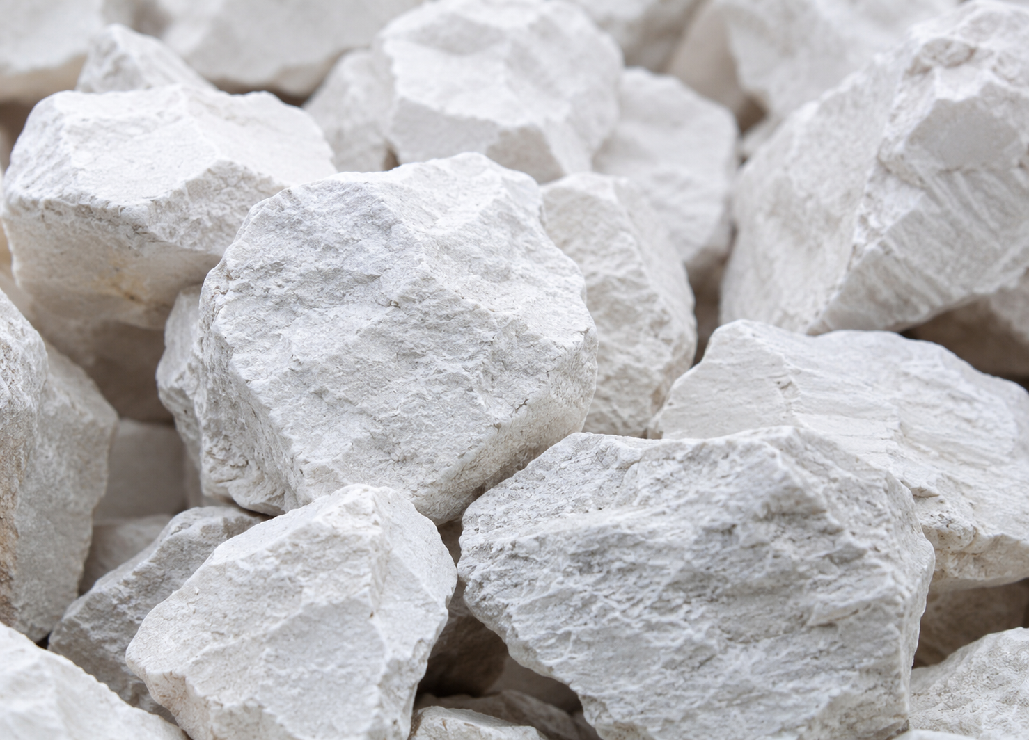 Raw limestone rocks and calcium carbonate powder — the natural materials used to make stone paper